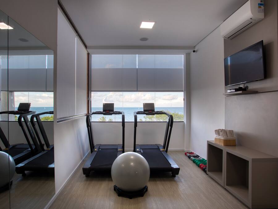 A gym with treadmills, a stationary bike, and exercise balls.