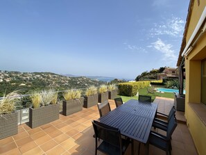 An outdoor patio with a table and chairs, a pool, and a view of a coastal landscape. - Holiday rental villa with swimming pool in Begur, Centre (Begur)