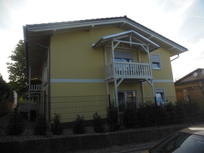 A two-story building with a balcony, a door, and a window. - Morgenstern fantastic holiday (Göhren)