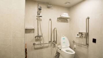 A modern bathroom with a walk-in shower, grab bars, and a toilet with a raised seat.