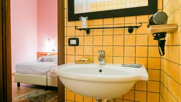 A bathroom with a sink, mirror, and towel rack.