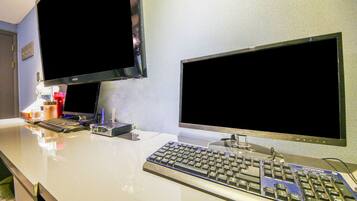 A modern office setup with two monitors, a keyboard, and a mouse on a white desk.
