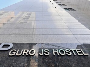 A sign for "GURO JS HOSTEL" on a tiled floor. - JS Hotel (Seoul)