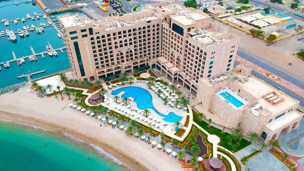 A hotel with a large pool, a beach, and a marina. - Al Bahar Hotel & Resort (Al-Fujairah)