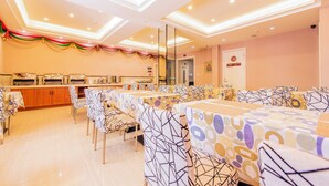 A banquet hall with multiple tables and chairs, a buffet area, and a modern ceiling design. - Xitang Hotel (Jiaxing)