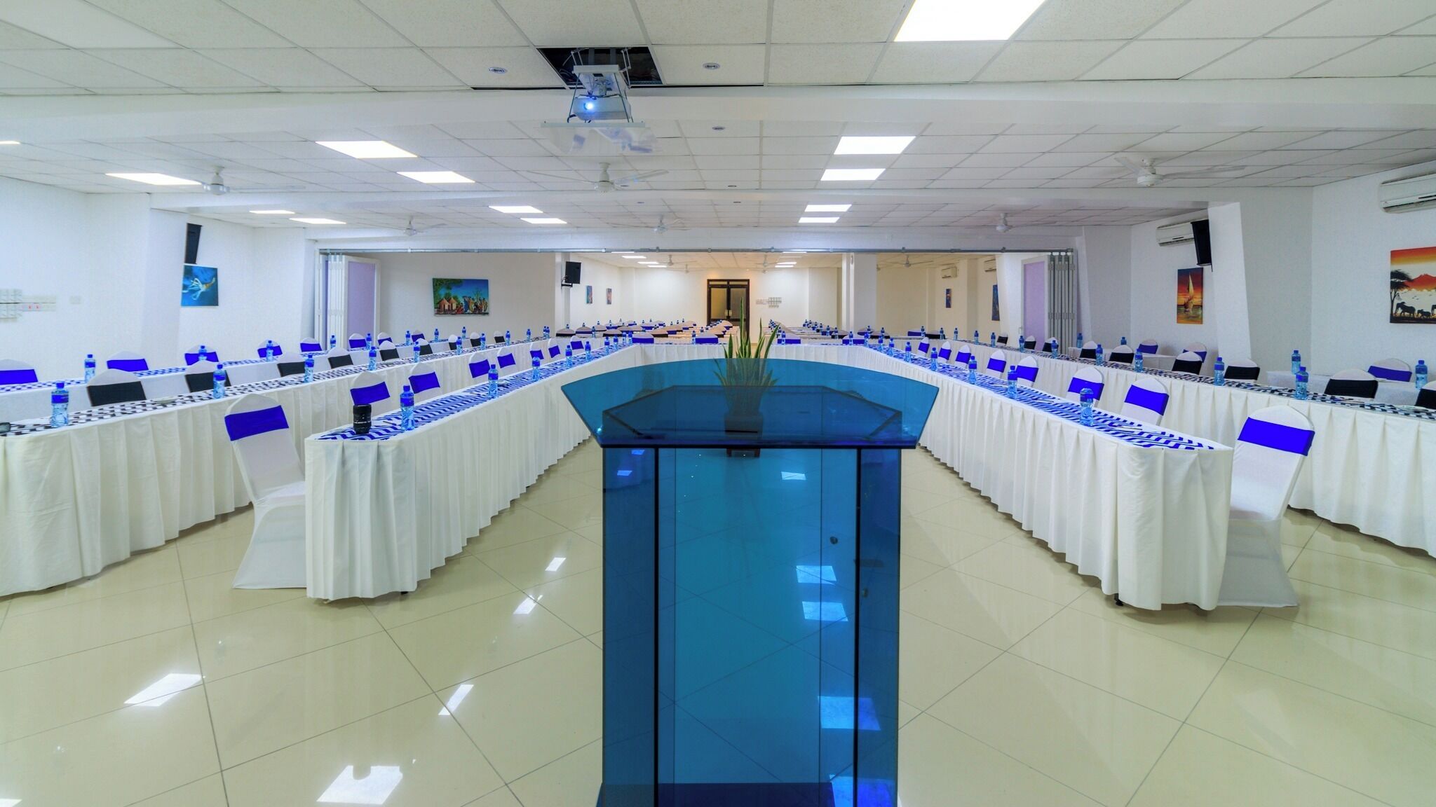A conference room with a long table, chairs, and a podium.