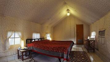 Cozy retreat with a large bed, bedside table, and patterned rug.