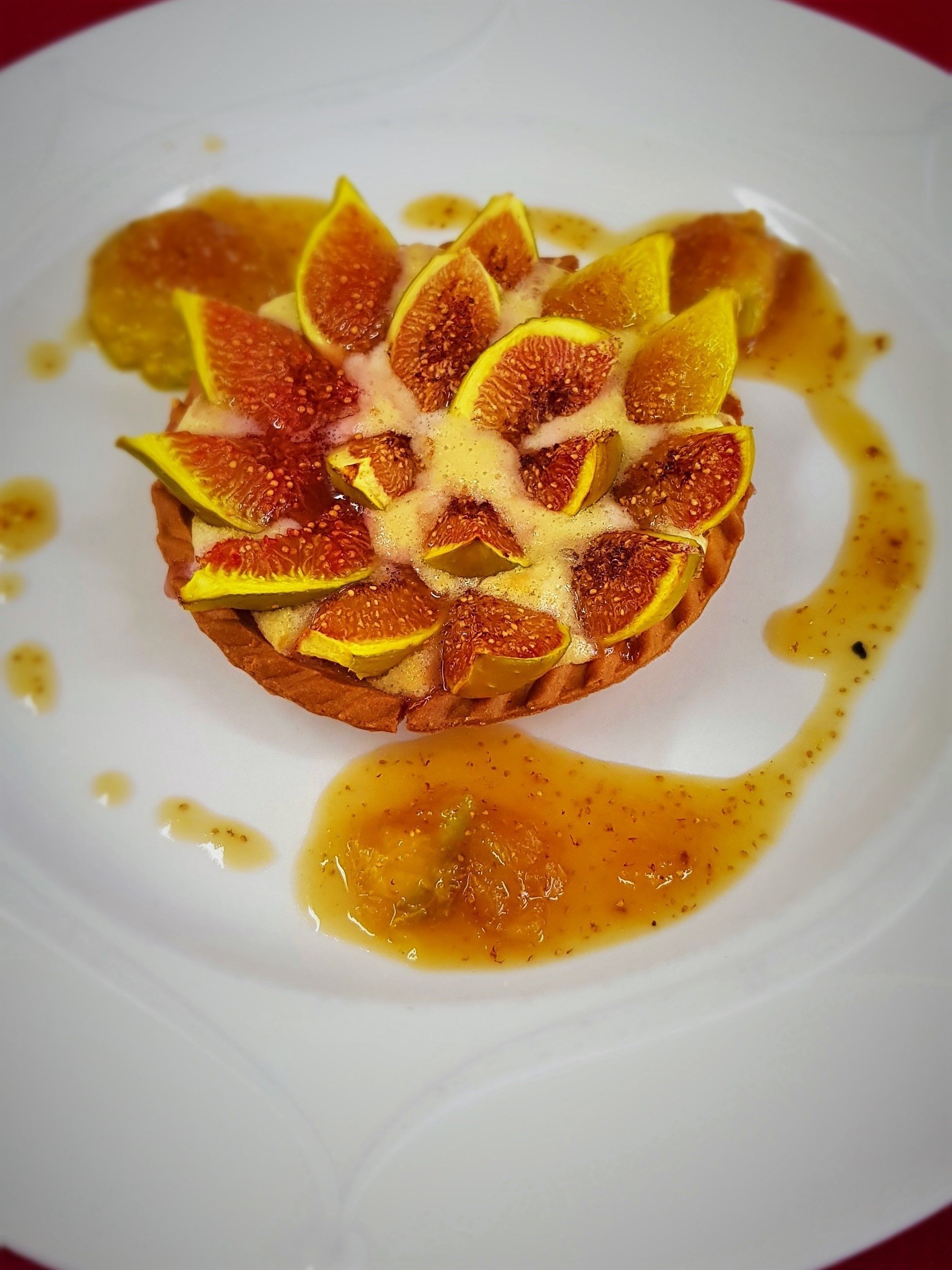 A dessert on a white plate with a caramel sauce.