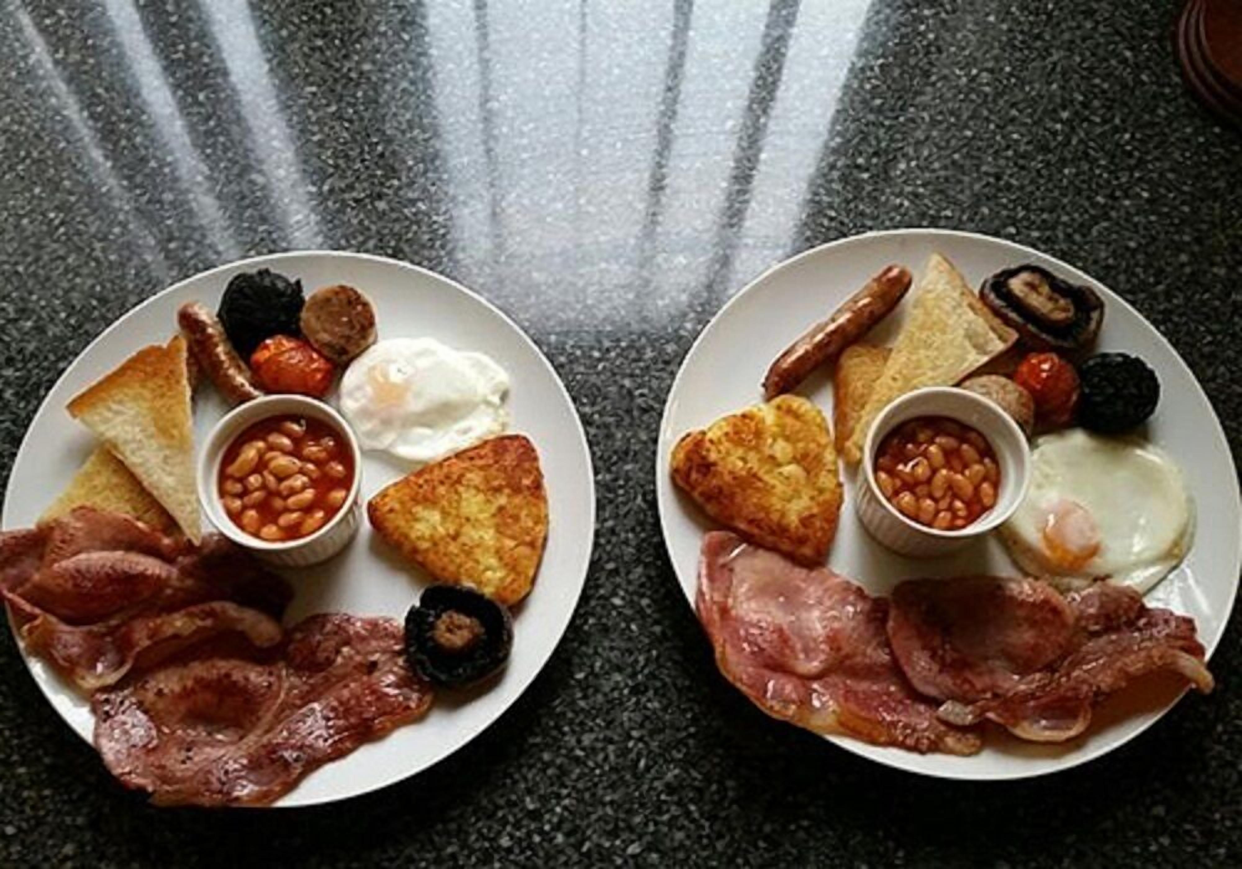 Two plates of breakfast food including eggs, bacon, beans, and toast.