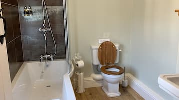 A modern bathroom with a bathtub, toilet, and sink.