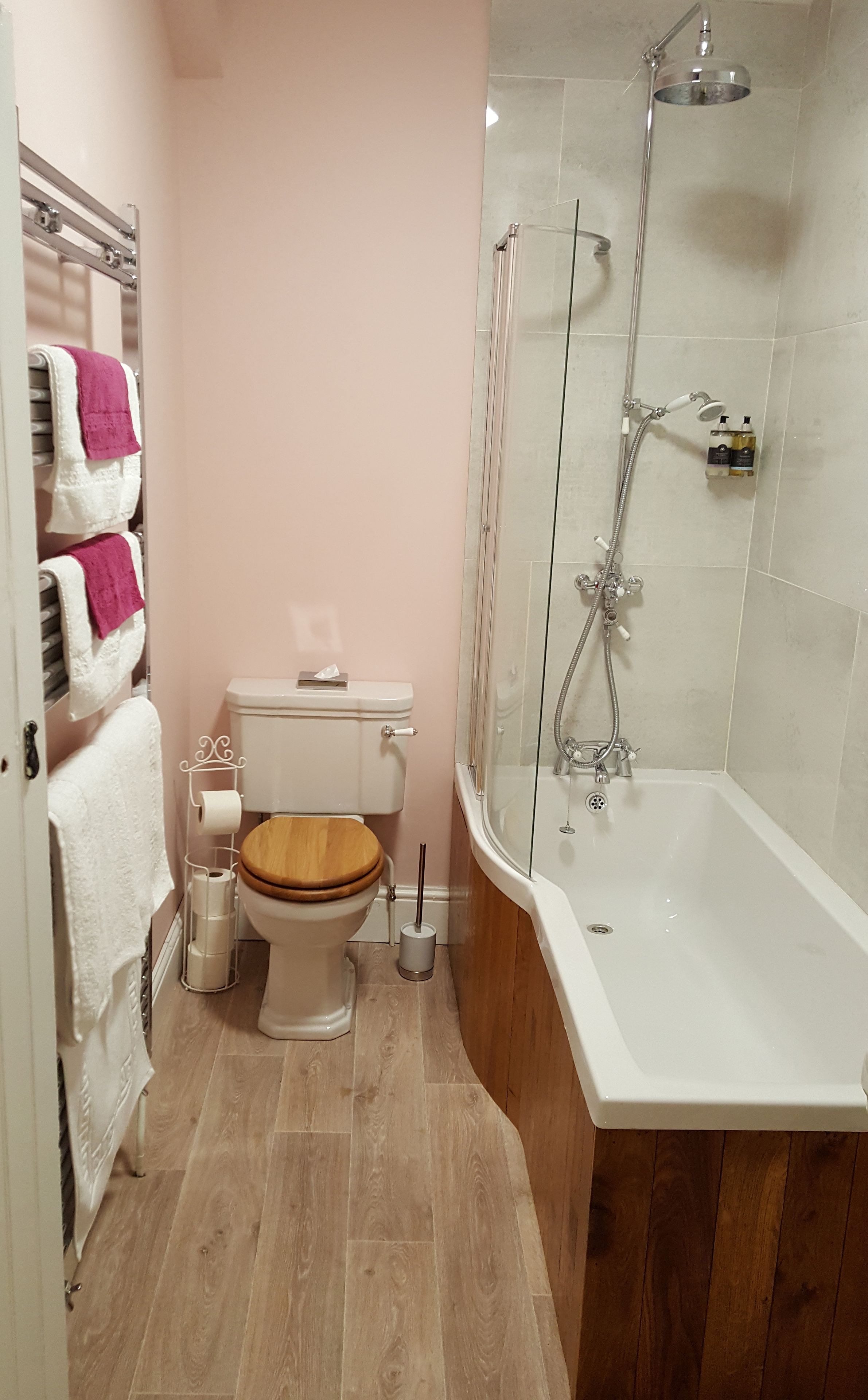 A bathroom with a toilet, a shower, and a bathtub.