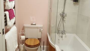 A bathroom with a toilet, a shower, and a bathtub.
