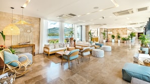 A spacious lobby with a seating area, large windows, and a view of the outdoors. - Monte Palm Beach (Durasevici)
