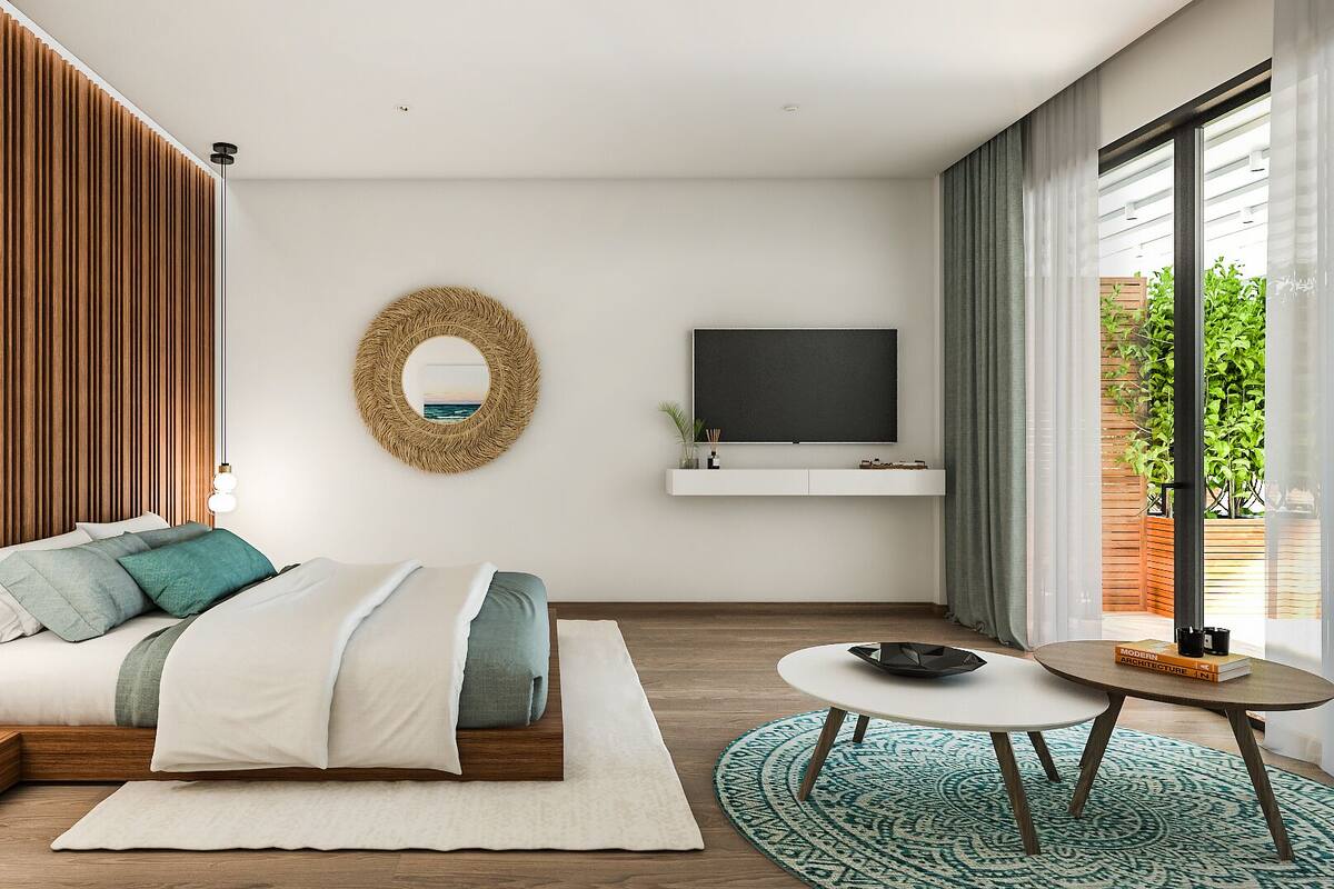 A modern bedroom with a bed, bedside tables, a TV, and a view of greenery outside.
