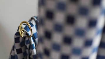 A checkered cloth hanging on a hook.
