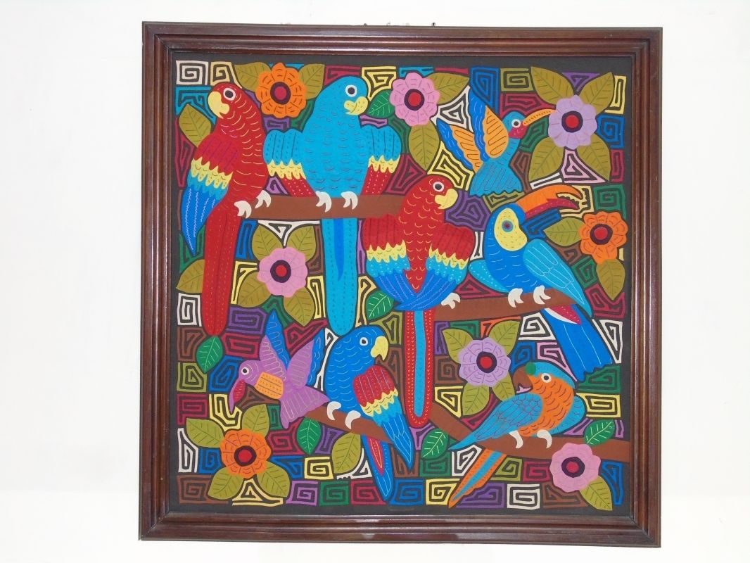 A framed artwork featuring colorful parrots and flowers.