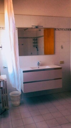 Combined shower/tub, deep soaking tub, hair dryer, bathrobes