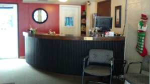 A reception desk with a sign that reads "RESORT". - The Resort (Falls of Rough)