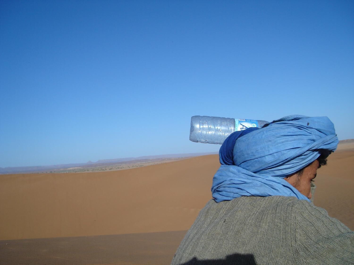 A person in a desert landscape with a clear sky.