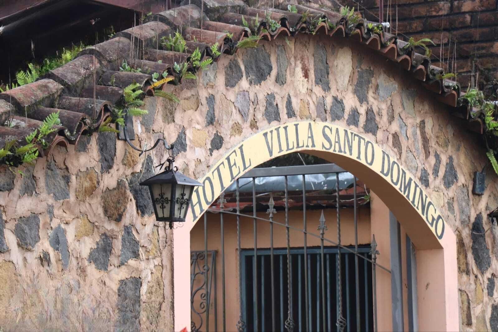 A stone building with a sign reading "Hotel Villa Santo Domingo."