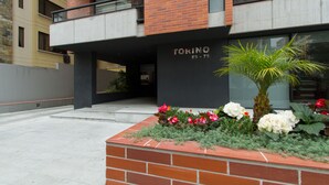 A modern building with a brick facade, a balcony, and a sign reading "TORINO E9-75". - Spacious, modern, GREAT LOCATION netflix, wifi, cable, 2BEDROOM, 2BATHROOM (La Carolina)