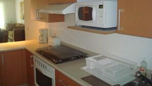 A compact kitchen with a microwave, toaster, and stove. - Nice Apartment, perfect for families!  (Diamante Lakes)