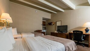 A hotel room with two beds, a desk with a computer, a television, and a chair. - Windjammer Lodge (Ogdensburg)