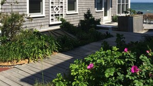 A two-story house with a deck and a view of the ocean. - Living on the edge! Breathtaking waterfront living at it’s best!  (Provincetown)