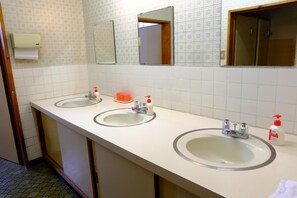 A bathroom with two sinks, a mirror, and a toilet. - Resort Inn Fujihashi (Fujikawaguchiko)