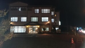 A multi-story hotel with a central entrance and a parking area in front. - Resort Inn Fujihashi (Fujikawaguchiko)