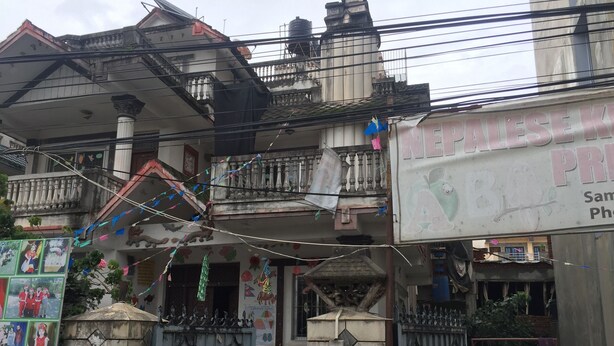 A residential building with a balcony, a signboard, and a gate. - Home aboard with the same feeling of home in Nepal  (Kathmandu)