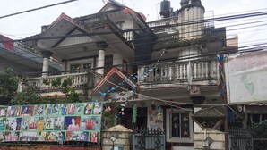 A residential building with a balcony, a gate, and a wall with children's drawings. - Home aboard with the same feeling of home in Nepal  (Kathmandu)