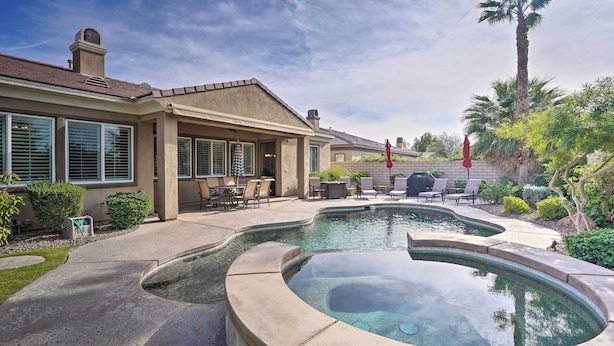 A residential property with a swimming pool, patio furniture, and a well-maintained garden. - 6 Mi to Coachella: Updated Home w/ Pool & Spa (Indio)