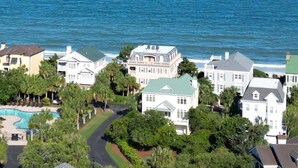 A coastal residential area with houses, a swimming pool, and a view of the ocean. - Cordy Beach House - 2nd Row Ocean View, Gated with Pool! (Pawleys Island)