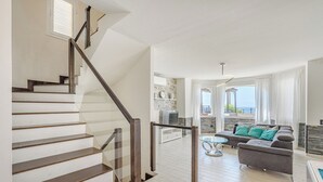 A modern living room with a staircase, a sofa set, and a view of the outdoors. - ..it's your place!... (Los Cristianos)