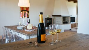 A wooden table with a wine bottle, two glasses of white wine, and a corkscrew. - QUERCIA apartment, 210 sqm with shared swimming pool (Santa Maria Nuova)