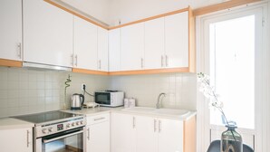 A modern kitchen with white cabinets, a built-in oven, a microwave, and a sink. - Modern Design Apartment Near Acropolis 2 (Athens)