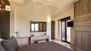 A modern bedroom with a large bed, a vanity with a mirror, and a sliding glass door leading to a balcony. - Villa Stellina, elegant villa, full privacy (Chania)