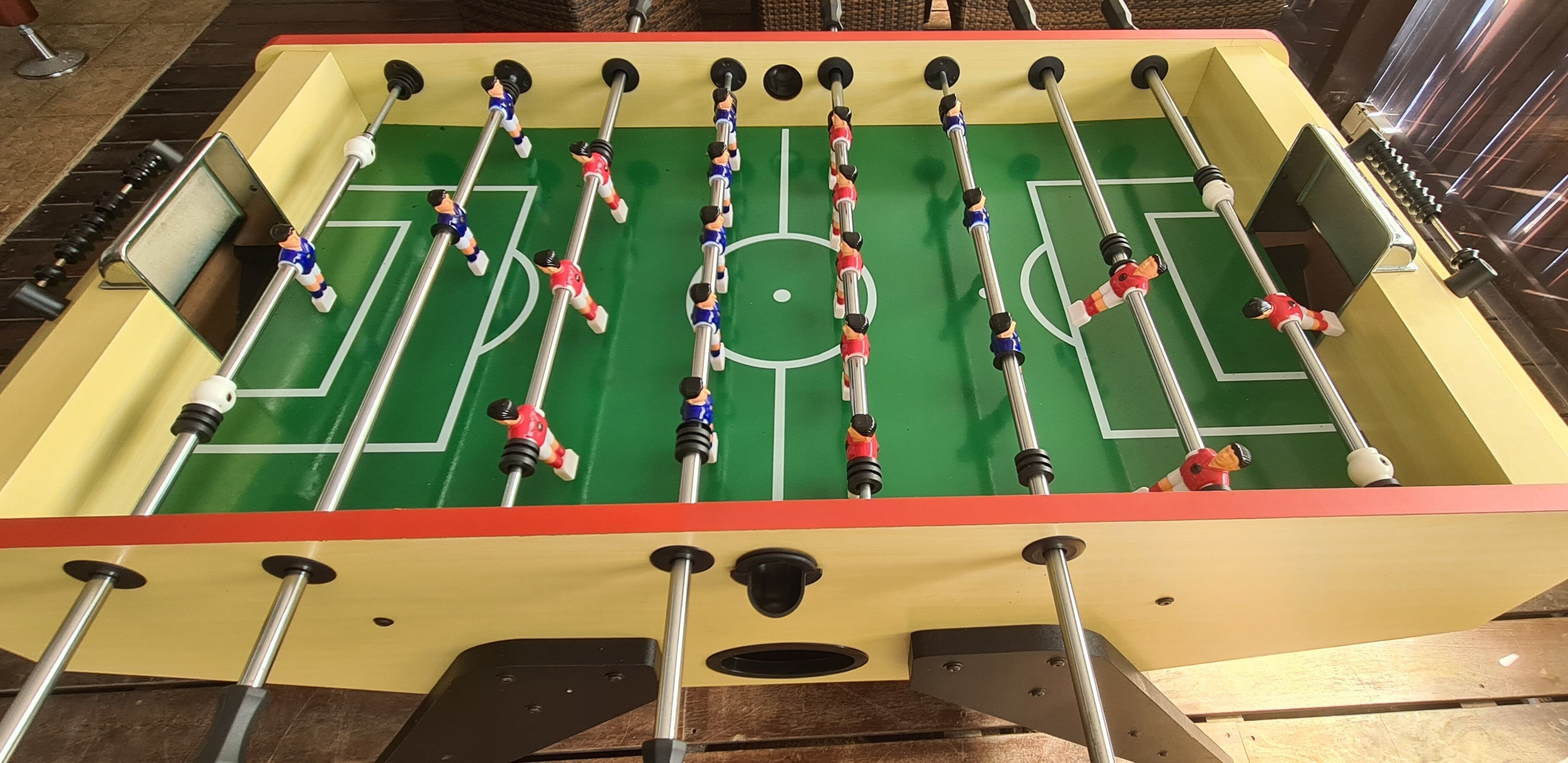A foosball table with multiple players and rods.