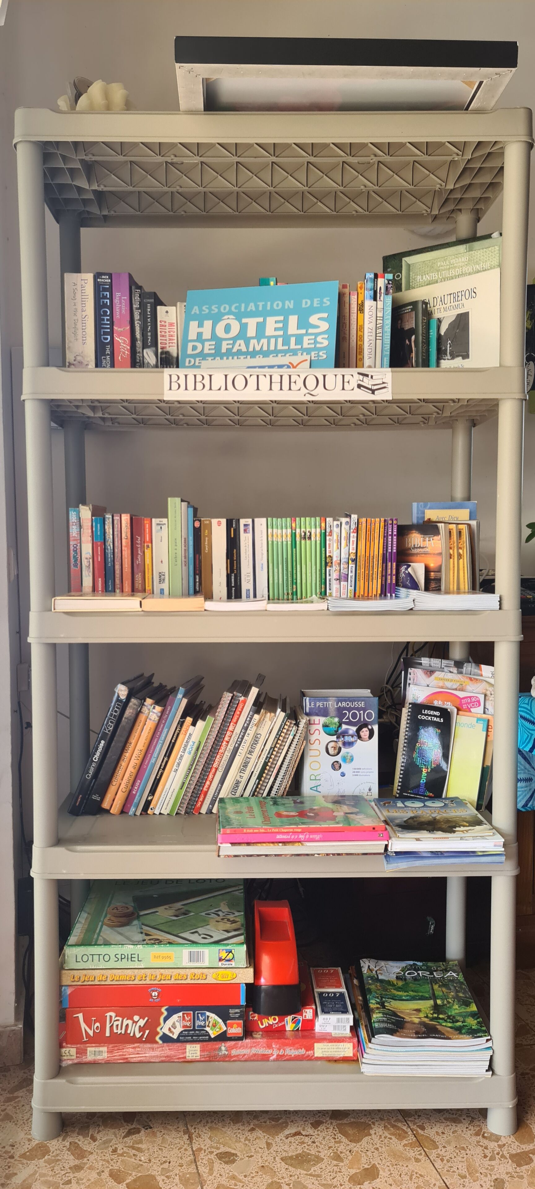 A bookshelf with various books and magazines.