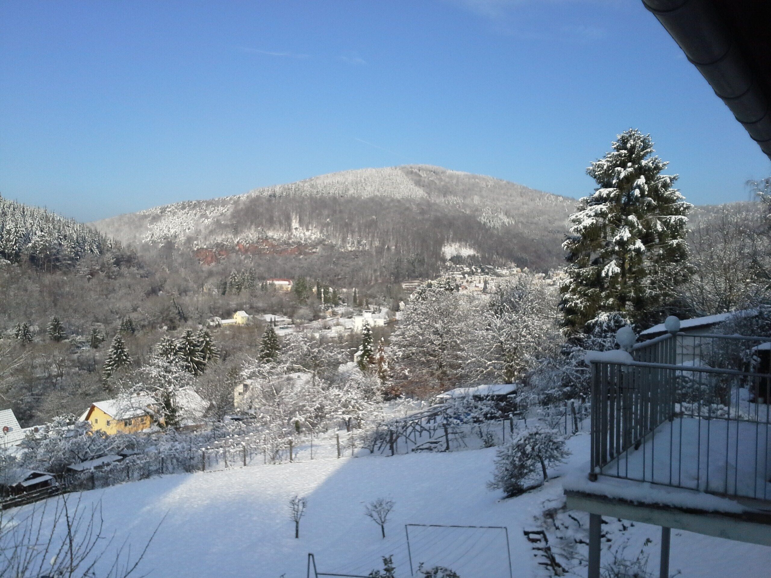 A snowy mountain landscape with a village in the valley.