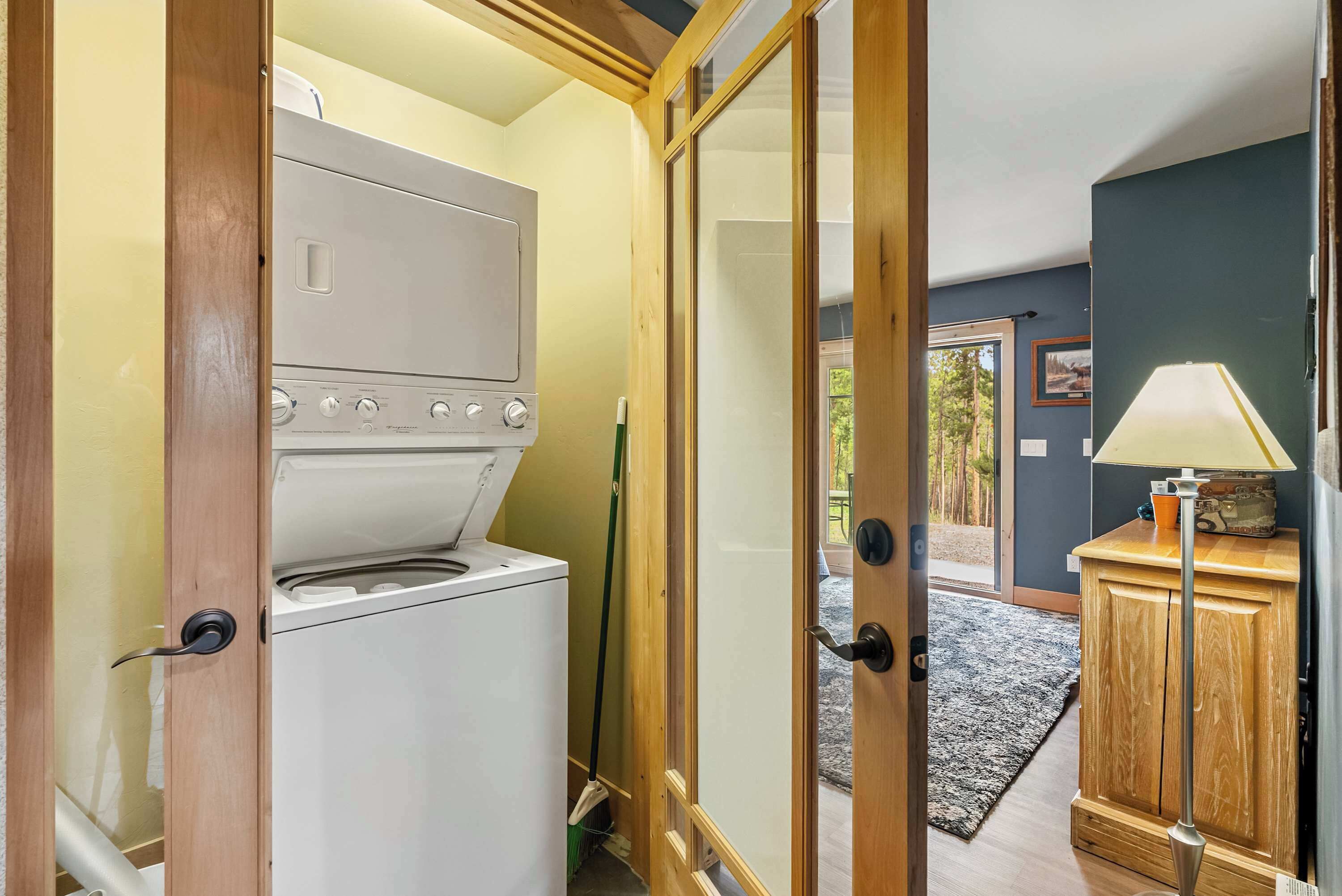 A compact kitchen with a built-in oven and a wooden cabinet.