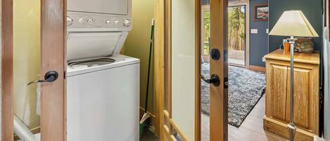 A compact kitchen with a built-in oven and a wooden cabinet.