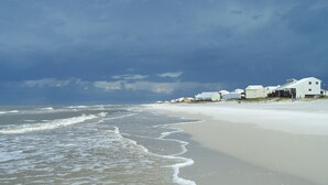 A beach with a row of houses along the shore. -  Beachfront, Beach Views, Great Location (Port St. Joe)