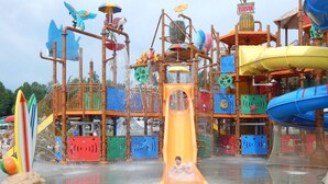 A water park with a central yellow slide, surrounded by various play structures and water features. - Lake Front Property on the main channel of Barkley Lake-Private Paradise (Eddyville)