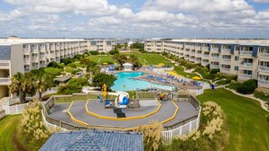 A resort with a central swimming pool, multiple balconies, and well-maintained lawns. - Direct OCEAN FRONT CONDO gorgeous view A Place at the Beach, Beautifully Updated (Atlantic Beach)