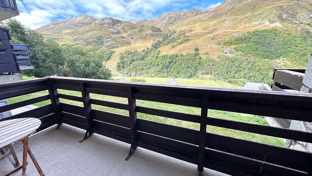 A balcony with a view of a mountainous landscape.