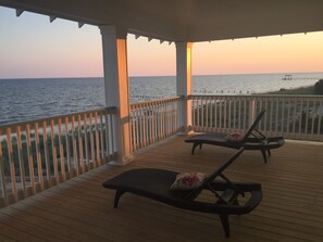 Relax on the deck overlooking the water with comfortable lounge chairs and pillows.