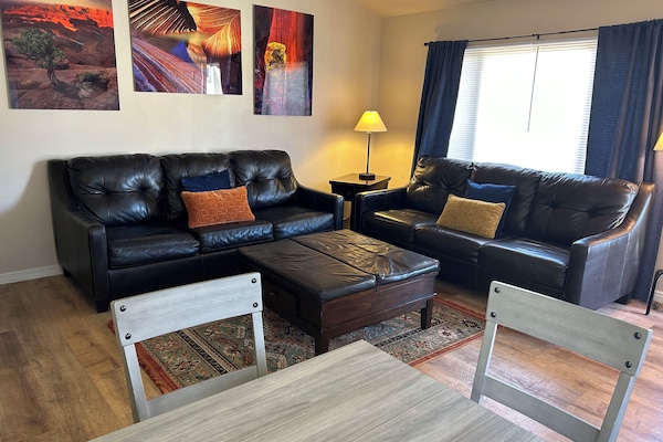 Living room with queen sofa bed and extra space on second couch.