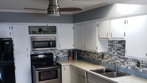 A compact kitchen with a stove, oven, microwave, and a dishwasher. - Beautiful Waterfront Home on Baugo Bay (Osceola)